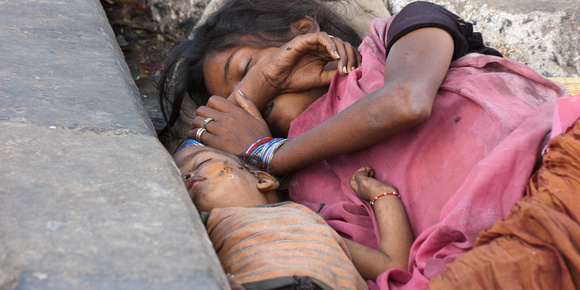 sleeping beggar girl with baby
